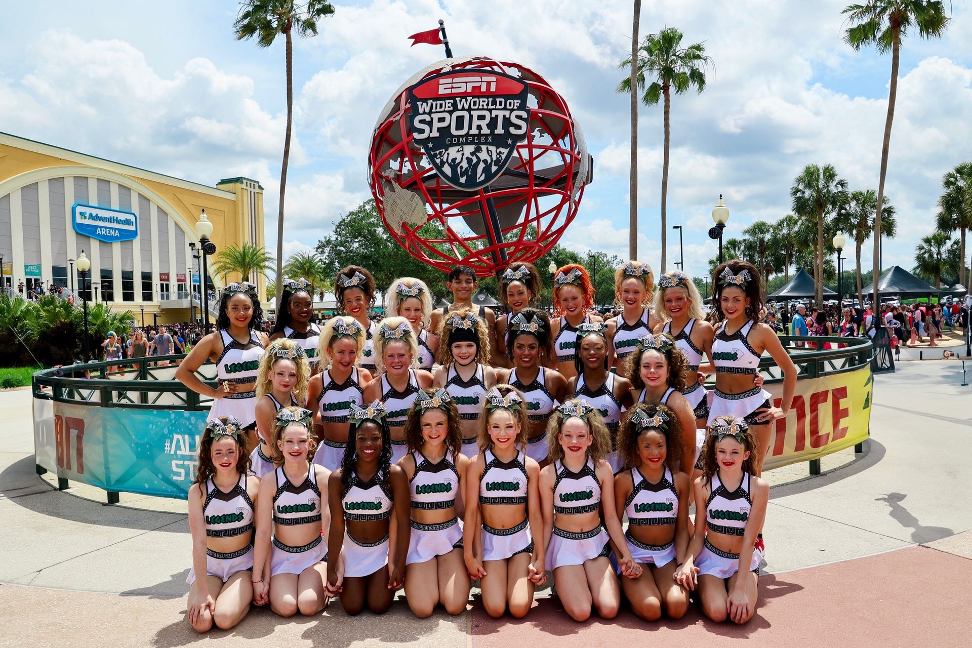 cheerleaders posing in front of espn wide world of sports